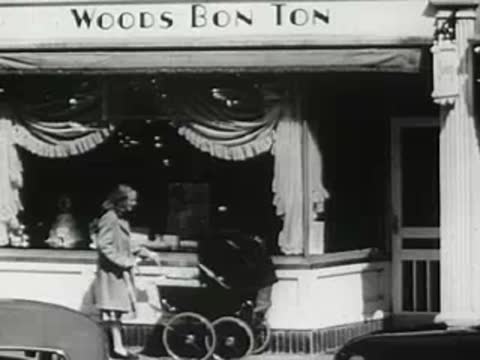 Woods Bon Ton store exterior where a woman pushes a stroller