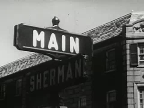 Street sign showing Main and Sherman intersections, 1940s.