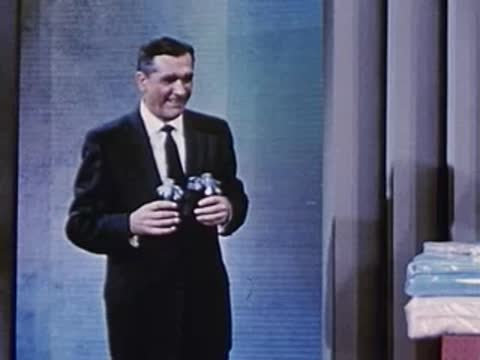man and woman holding a wrapped gift display, then man alone