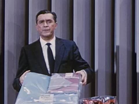 man picking up a large packaged item from the table