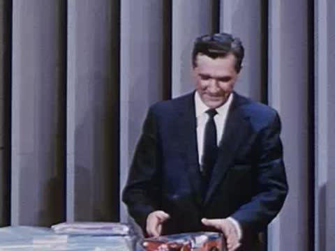 man placing packaged products neatly on a table display