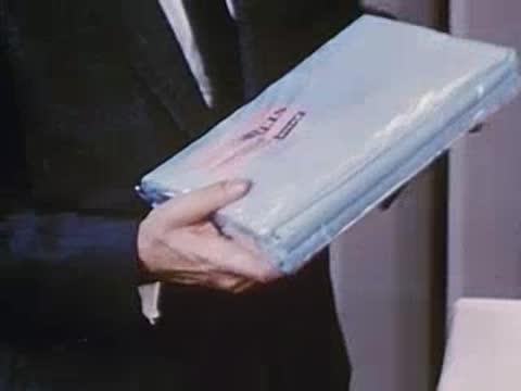 man bending a wrapped flat product to demonstrate flexibility