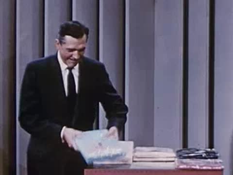 man holding and examining a flexible wrapped product package