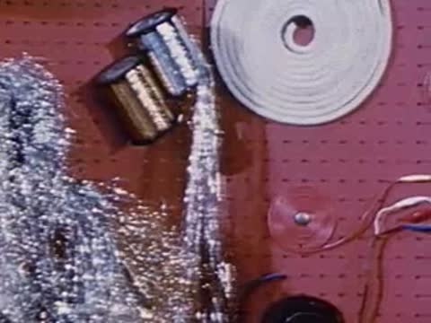 Close-up of display board with spools, tinsel, wire, and components