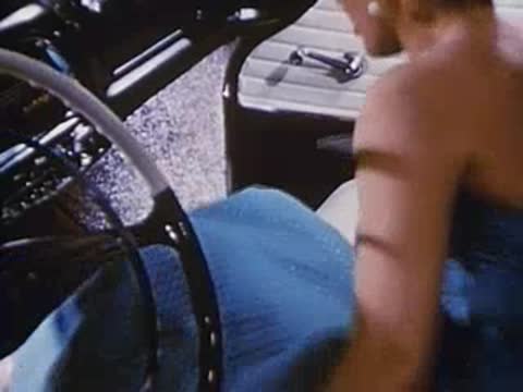 Woman opens the door and exits a convertible car
