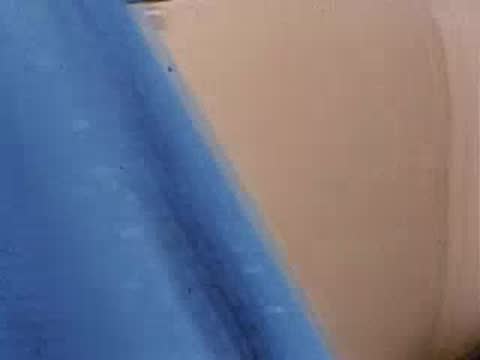 Close-up pan along side of convertible car exterior bodywork