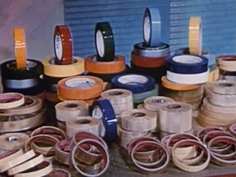 close-up view of numerous colourful tape rolls stacked on a table
