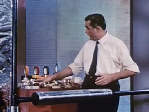 man selecting a roll of tape from a tabletop display