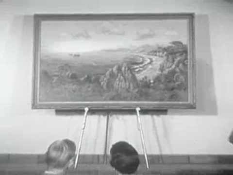 A painting of a coastal landscape displayed on an easel indoors.