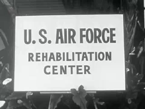 A sign for the U.S. Air Force Rehabilitation Center stands outdoors.