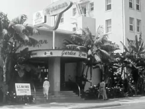 Exterior of a building labeled Garden Zoo with palm trees.