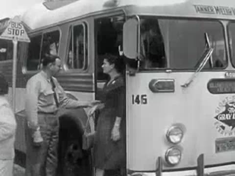 Passengers board a classic tour bus in 1950s California.
