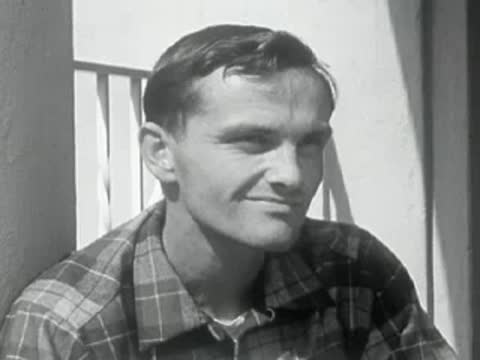 A close-up portrait of a smiling man outdoors.