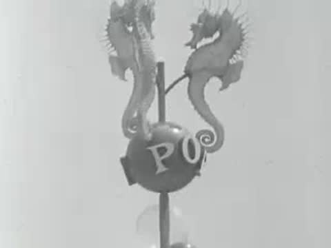 Decorative seahorse sculptures and balloons at an amusement park entrance.