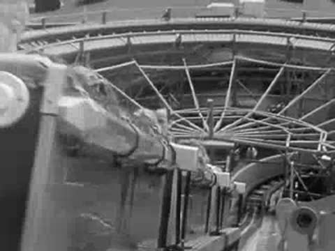 POV shot riding a roller coaster at an amusement park in 1959.