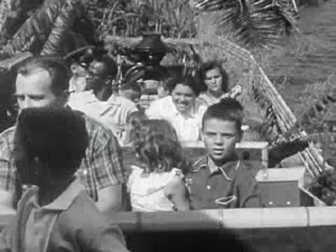 Diverse group of visitors riding an amusement park water attraction.