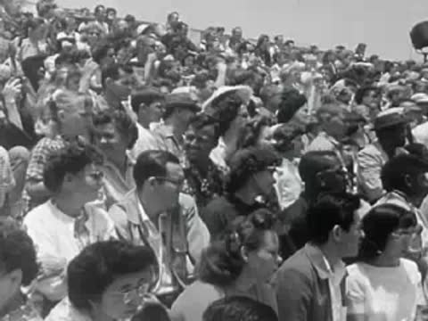 Large audience of spectators applauding and watching a show.