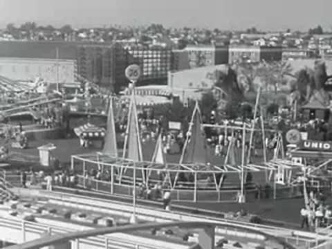 High-angle view of Malibu fairground and coastal buildings with vintage rides in the 1950s.