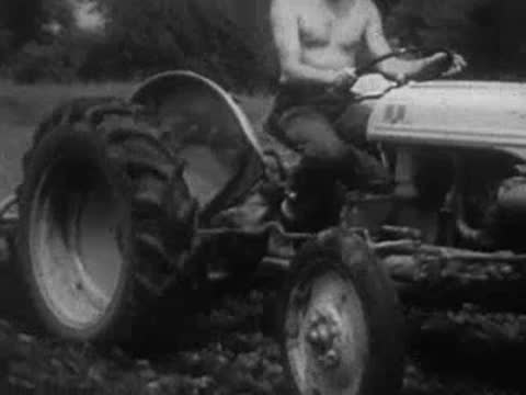 Man driving a tractor through a field.