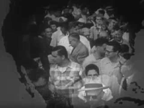 Large crowd of diverse people gathered outdoors, viewed from above through a map overlay.