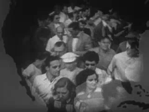 Large crowd of people looking toward the camera outdoors.