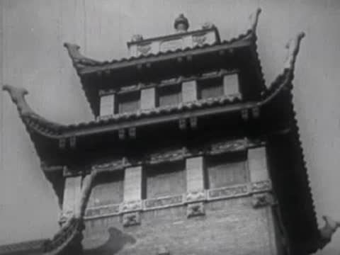 Traditional Chinese architectural structure, tiered pagoda roof against dark sky
