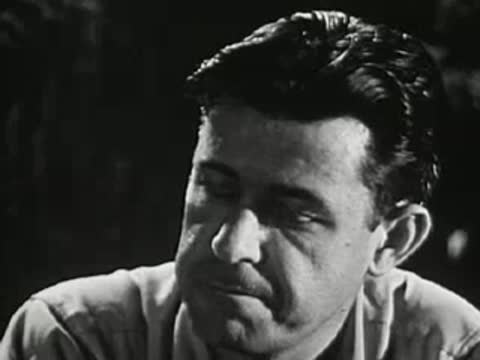 Man talking and listening in a group setting at night