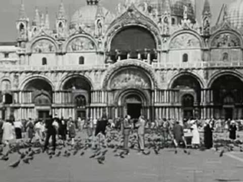 St. Mark's Basilica in Venice with people and pigeons in the square