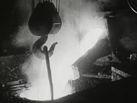 Industrial metal smelting, pouring glowing molten metal from ladle, factory interior