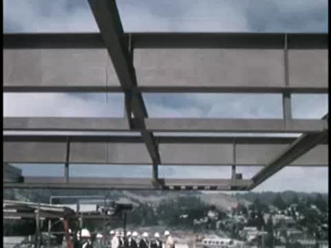 Precast concrete structural beams forming a bridge or building framework.