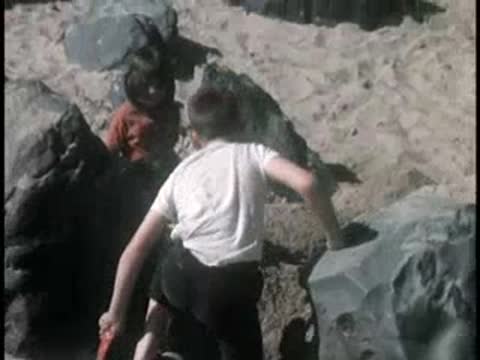 Children playing in sandbox near construction area