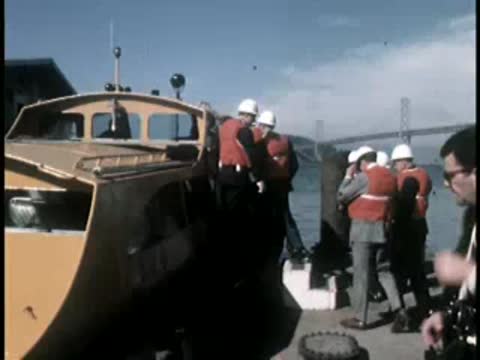 Passengers boarding a passenger boat or ferry at a dock.