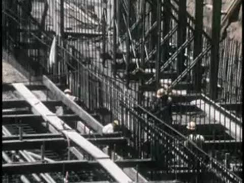 Complex structural rebar gridwork and construction forms on a site.