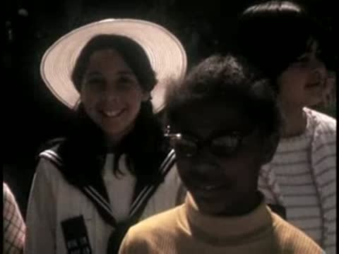 Close-up of young girls smiling in a crowd