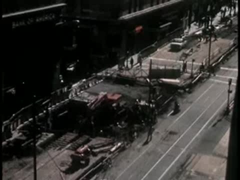 High angle view of busy urban street excavation and construction zone.