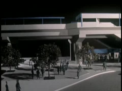 Modern multi-level building exterior with people walking nearby.