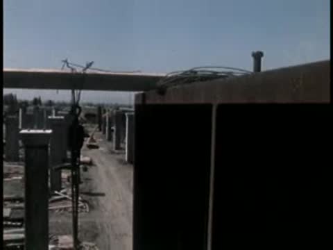 View along a row of concrete vertical pillars on a construction site.