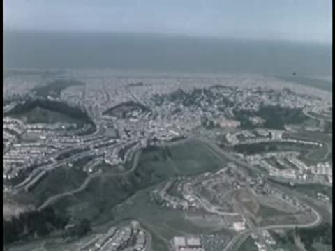 High aerial view of coastal city and hills