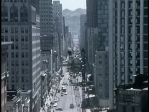 View down a narrow city street lined with tall buildings.
