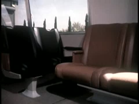 Empty brown upholstered seats inside the modern transit train.