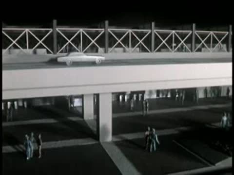 Architectural model showing cars driving on an elevated roadway structure.