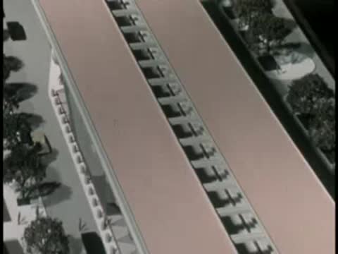 Overhead view of an architectural scale model of a transit station.