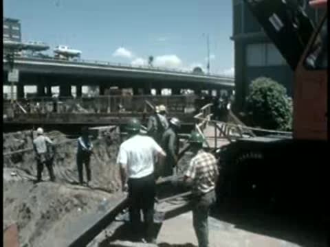Workers gathered around construction site and crane