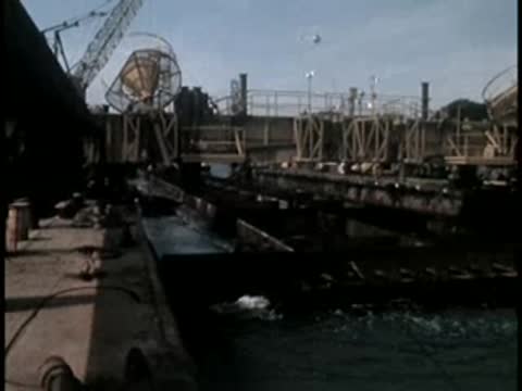 Industrial machinery and equipment on a barge operating in the water.