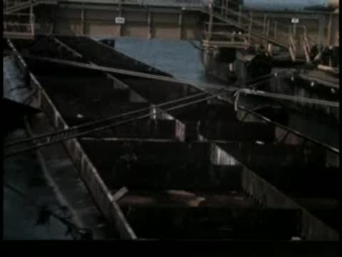Pan across an industrial construction barge with compartments and equipment.
