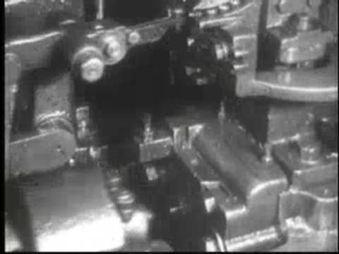 Mechanical linkage moving rapidly in an industrial machine setup.