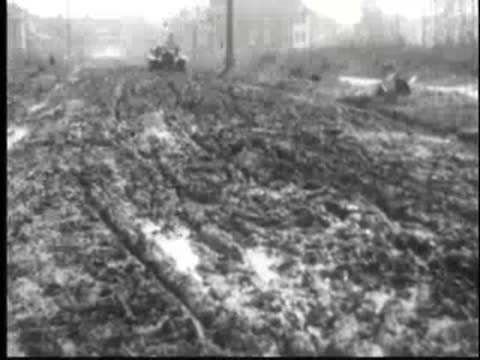 a car driving through a muddy and rough terrain