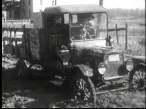 a vintage delivery truck parked outdoors in a rural area