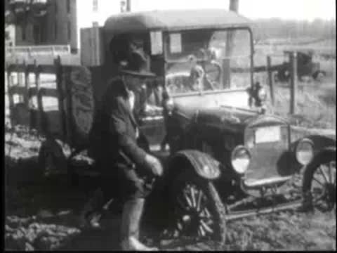 an adult getting out of a vintage delivery truck