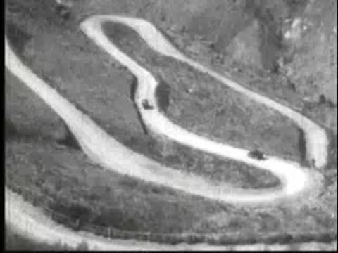 Aerial view of a winding mountain road with vehicles driving.